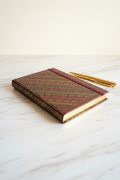 Burgundy diagonal stripe gilded A6 journal on marble desk
