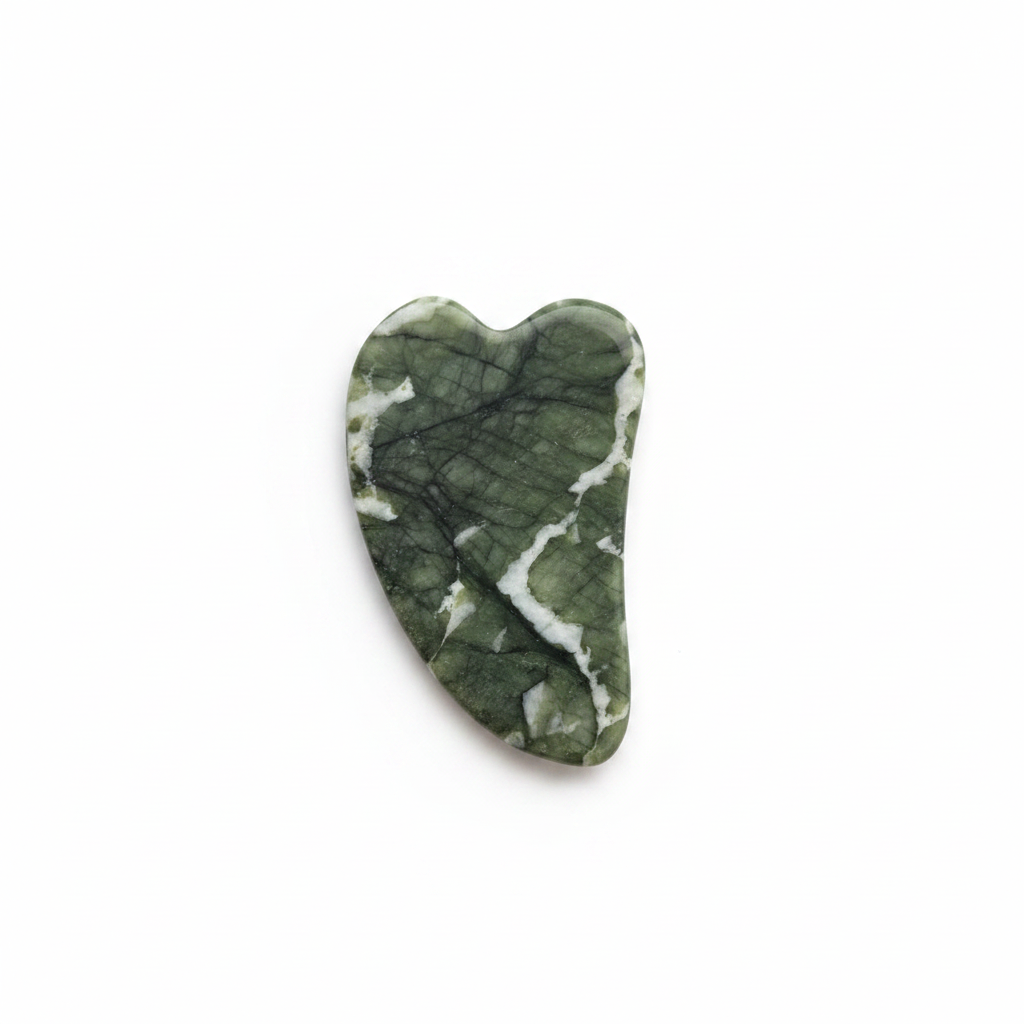 Heart shaped jade gua sha stone in dark green with white veining