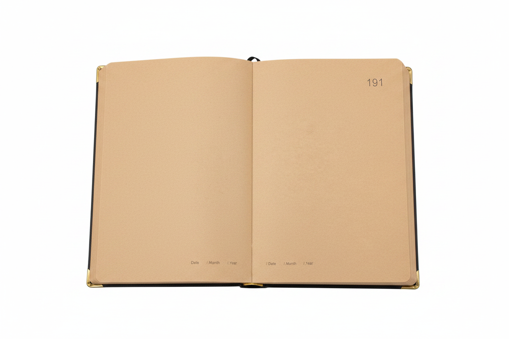 Interior pages of gold filigree journal showing numbered kraft pages with date fields