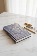 Blue marbled gold embossed hardcover journal on marble desk