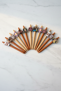 10 coffee saying charm pens with 3D rubber toppers on marble desk